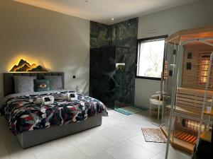 En eller flere senge i et værelse på Villa BHD-Lodge & Spa, la tentation du luxe