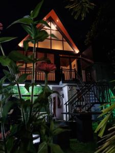 a house at night with a plant in front of it at Batti Lagoon Hotel in Batticaloa