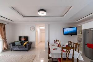 a living room with a table and a couch at Borrowdale Top End - Apartments in Harare