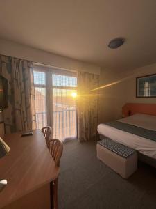 a hotel room with a bed and a window at Hotel le France, Redon in Redon