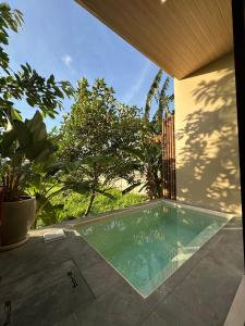 a swimming pool in the backyard of a house at KAIA Canggu in Canggu
