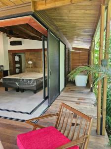 een kamer met een bed op een houten terras bij Bois de Songe in Sainte-Rose