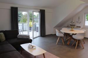 a living room with a couch and a table at Sprem06 in Elsterheide