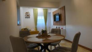 a living room with a dining room table and chairs at Apartmani Flocke Vlašić in Šišava +4 photos