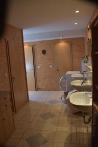 a bathroom with two sinks and two toilets at Pension Aigner in Waldkirchen