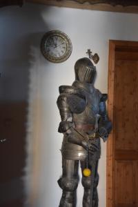 a statue of a knight next to a clock on a wall at Pension Aigner in Waldkirchen