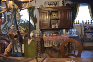 a dining room with a table and a cabinet at Pension Aigner in Waldkirchen