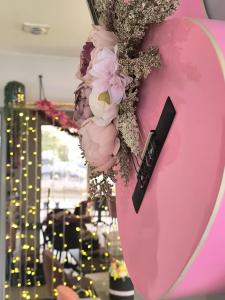 a bunch of flowers hanging from a pink wall at Hôtel Saint Jacques in Parthenay