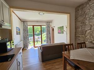 a kitchen and living room with a couch and a table at Apartmány Krásné zátiší in Krásno