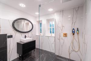 a bathroom with a sink and a mirror at NEU! HeideVilla - Private Pool, Sauna & Mini Golf in Asendorf