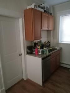 a kitchen with brown cabinets and a counter top at Shared Salem Apt for staying in a bed in Salem