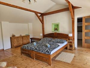 a bedroom with a bed with a zebra print sheets at Apartmány Krásné zátiší in Krásno