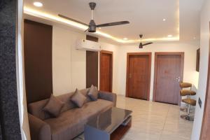 a living room with a couch and a glass table at Apna Ghar in Jaipur