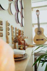 a kitchen counter with a guitar on the wall at Mahakala Center in Petrovac na Moru