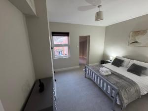 a bedroom with a bed and a window at 25 Birks Road in Cleator Moor