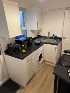 a kitchen with a sink and a washing machine at 25 Birks Road in Cleator Moor +11 photos