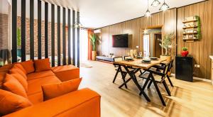 un soggiorno con divano arancione e tavolo in legno di Beachfront Central Apartments a Durrës
