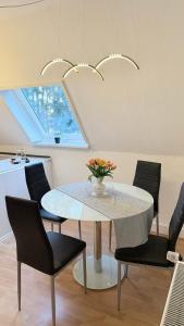 une salle à manger avec une table et des chaises noires dans l'établissement Fichtenblick, à Selb 1 autre photo