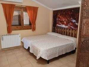 een slaapkamer met een bed en een raam bij Casa Rural LOS CORTESES in Los Díaz +58 foto's