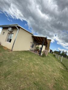a house with a large yard in front of it at Complejo Aires del Cielo in San José +14 photos