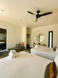 a bedroom with two beds and a ceiling fan at Casa Zala in El Paredón Buena Vista