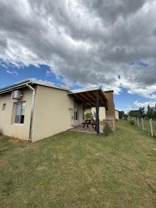 een klein huis met een picknicktafel in de tuin bij Complejo Aires del Cielo in San José