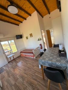 a bedroom with a table and a bed in a room at Complejo Aires del Cielo in San José