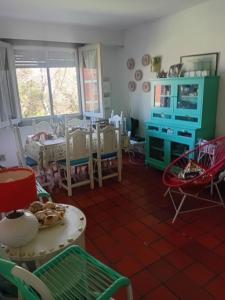 a living room with a table and chairs at Valeria del Mar Apartment in Valeria del Mar