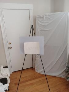 a white sign on a tripod in front of a door at Shared Salem Apt for staying in a bed in Salem