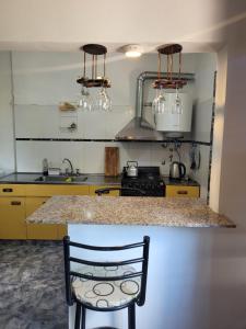 a kitchen with a counter and a sink and a stove at Casa Paraiso Serrano in Valle Hermoso