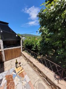 a patio with a table with a bottle of wine on it at Casa Paraiso Serrano in Valle Hermoso