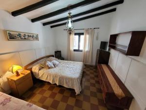 a bedroom with a bed and a flat screen tv at Casa Paraiso Serrano in Valle Hermoso
