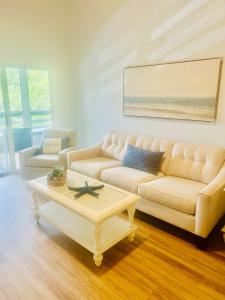 a living room with a couch and a coffee table at Blue Skies Seaside Veranda in New Smyrna Beach