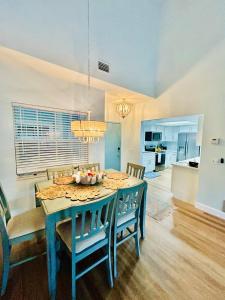 a kitchen and dining room with a blue table and chairs at Blue Skies Seaside Veranda in New Smyrna Beach