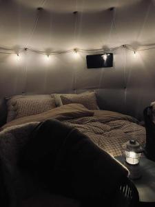 a room with a bed in a tent with lights at Torshaug glamping in Trondheim