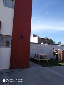 a picnic table sitting next to a building at Departamentos Necochea in Necochea +12 photos