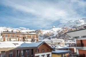 a view of a town with snow covered mountains at Ski Gate - Main Street by Cervino View Experience in Breuil-Cervinia +15 photos