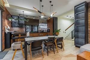 a kitchen and dining room with a table and chairs at Die SONNE in Bukovel