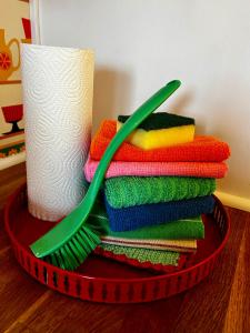 a red basket with a stack of towels and a toothbrush at Holiday Home Skoaffär in Lakene +45 photos