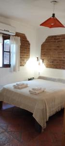 a bedroom with a bed with two towels on it at maemm el castillto in Mina Clavero