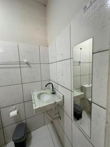 a bathroom with a sink and a mirror and a toilet at Preá Beach Flat in Cruz +26 photos