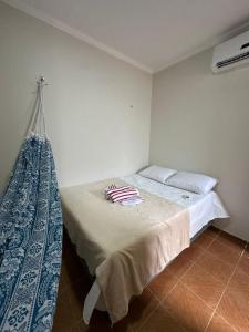 a bedroom with a bed with two towels on it at Preá Beach Flat in Cruz