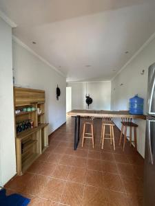 a kitchen with a counter and stools in a room at Preá Beach Flat in Cruz