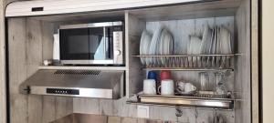 een keuken met een magnetron en keukengerei bij Seaside studio with swimming pool & parking #2 in Kassandria