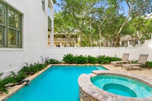 een zwembad in een tuin naast een huis bij Sylvia's Cottage in Rosemary Beach