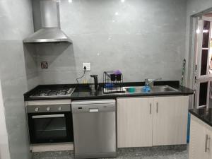 a kitchen with a stove and a sink at Protea Place Cottage in La Mercy