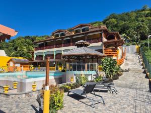 a large building with a pool and a gazebo at Résidence Simona Premium in Deshaies