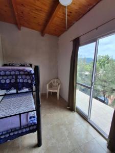 a bedroom with bunk beds and a large window at Casa de campo Pajarito in San Fernando del Valle de Catamarca