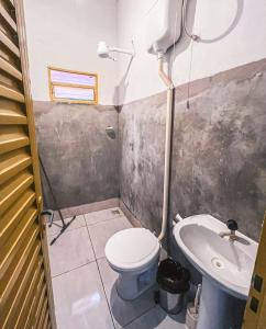 een badkamer met toilet en wastafel bij Chalé Azul Aurora in Manhã