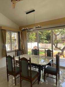 a dining room with a table and chairs at Atishay Villa I 4BHK I Pure veg I Pvt Pool & lawn in Lonavala